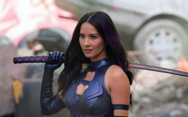 Olivia Munn portrays Psylocke in X-Men: Apocalypse, holding her sword confidently amidst a chaotic backdrop, captured in stunning 8K Ultra HD detail.