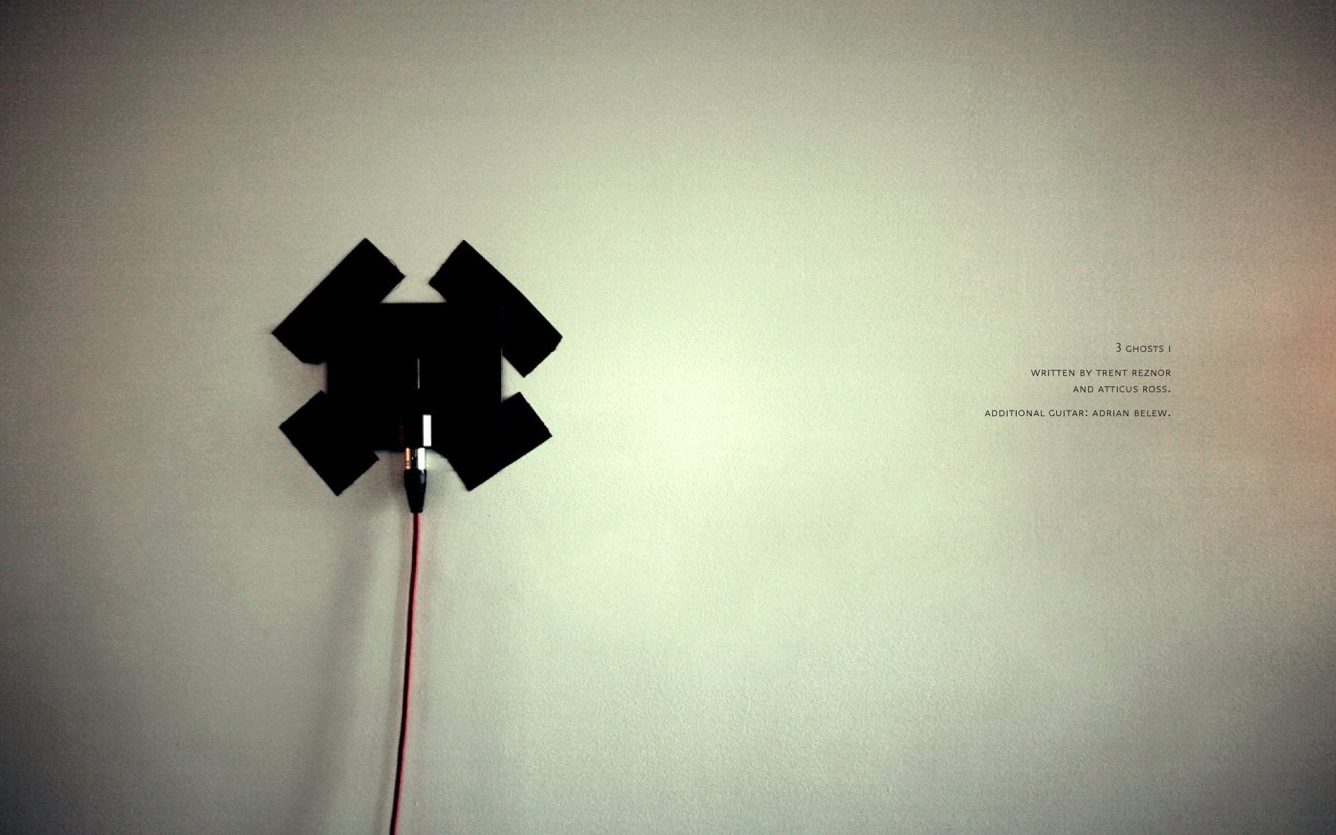 Minimalist HD PC desktop wallpaper featuring the Nine Inch Nails logo with a light gray background and subtle text, capturing a modern music aesthetic.