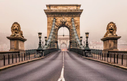 HD desktop wallpaper of Budapest’s Chain Bridge in Hungary, featuring stone lion statues guarding the historic man-made structure over the Danube River.