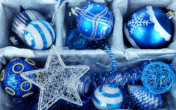 Blue and silver Christmas ornaments, including stars and baubles, arranged in a festive display, featured as a HD PC desktop wallpaper and background.