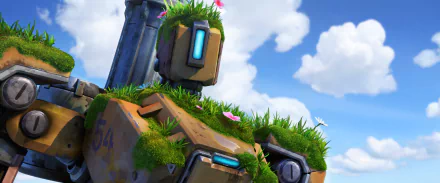 HD PC desktop wallpaper featuring Bastion from Overwatch, set against a bright blue sky with fluffy clouds, highlighting the video game's iconic robot character with grass and flowers.