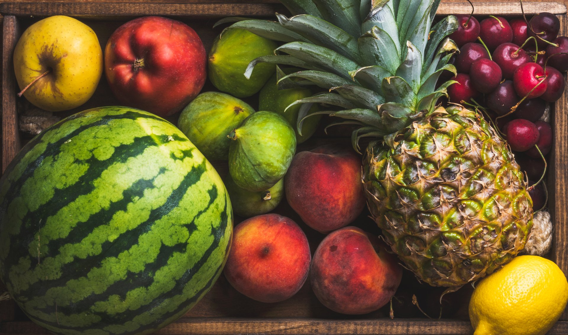 Vibrant 4K Ultra HD wallpaper featuring a colorful assortment of fresh fruits including watermelon, pineapple, cherries, apples, peaches, and lemons.
