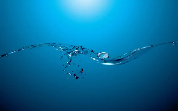 HD desktop wallpaper depicting a water drop splashing amidst serene blue tones, capturing the essence of nature.