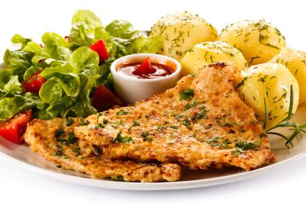 A 4K Ultra HD desktop wallpaper showing a meal with grilled meat, boiled potatoes topped with herbs, fresh salad, and a small bowl of ketchup on a white plate.