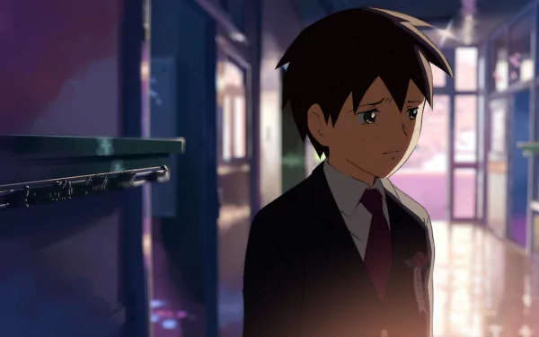 HD anime wallpaper featuring Takaki Touno from 5 Centimeters per Second, standing thoughtfully in a softly lit corridor with a moody, reflective atmosphere.