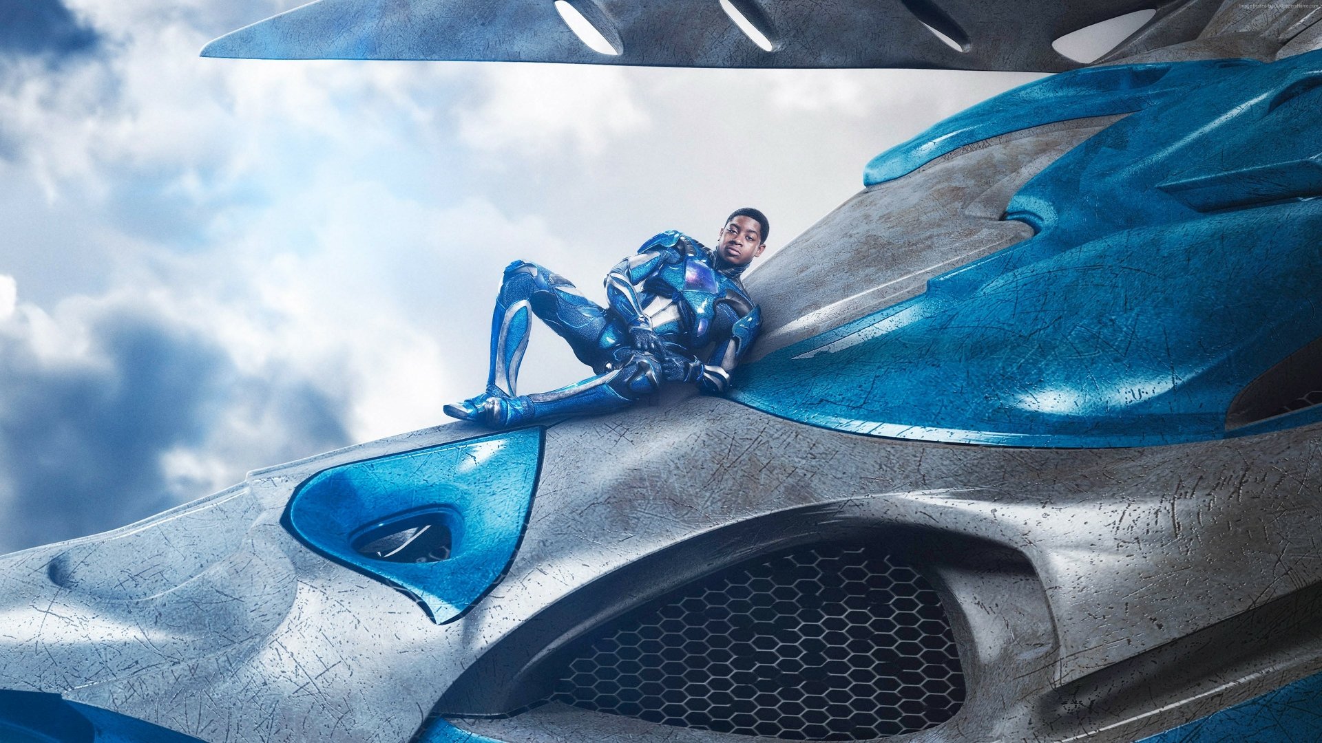 Billy Cranston as the Blue Ranger from Power Rangers (2017) sits atop a Zord in this dynamic 4K Ultra HD wallpaper, showcasing action and adventure in the Power Rangers universe.