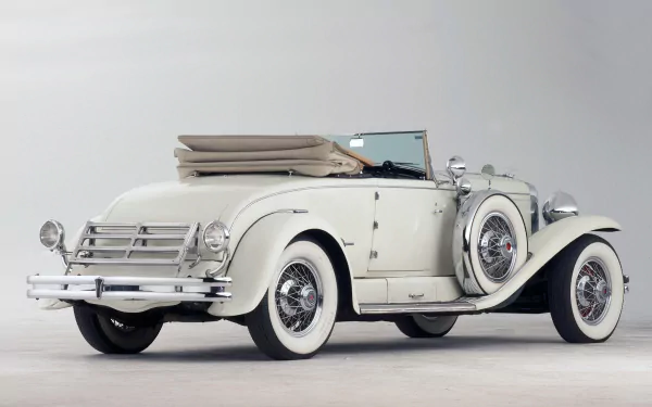 1929 Duesenberg Model J Convertible Coupe vintage car — white classic vehicle on a neutral background, HD PC desktop wallpaper.