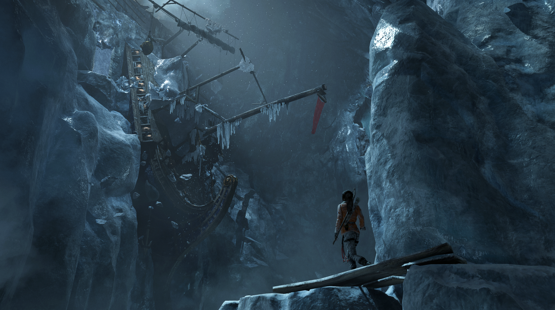 HD PC desktop wallpaper from Rise of the Tomb Raider showcasing Lara Croft facing a massive frozen spider trap in a dark, icy cavern environment.