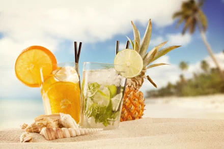 A 4K Ultra HD wallpaper featuring refreshing summer cocktails in glasses on sand, accompanied by a pineapple and seashells with palm trees blurred in the background.