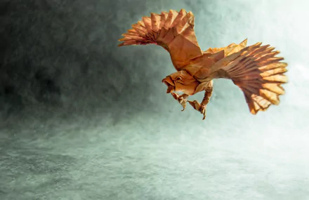 A stunning HD desktop wallpaper featuring a man-made origami bird, intricately designed to resemble a soaring hawk against a soft, textured background.