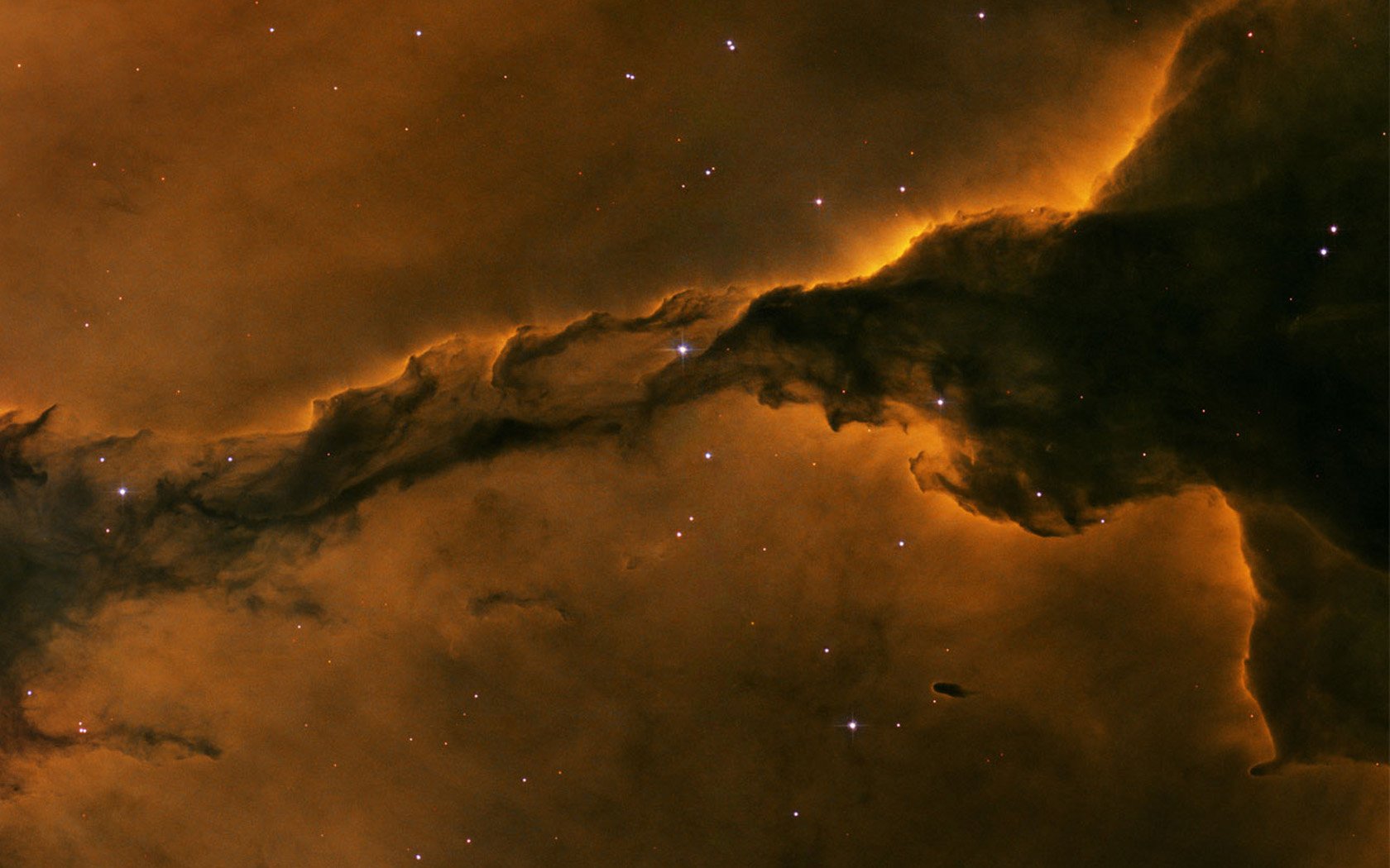 A stunning sci-fi nebula with swirling clouds of orange and black, offering a captivating HD wallpaper and background for space enthusiasts.