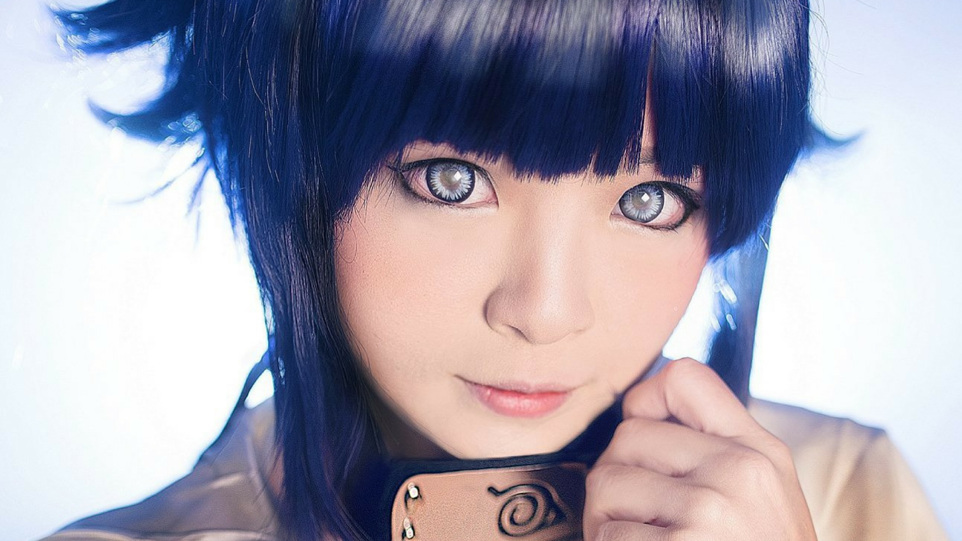 HD desktop wallpaper featuring a close-up of a woman cosplaying Hinata Hyuga from Naruto, showcasing detailed makeup and costume.