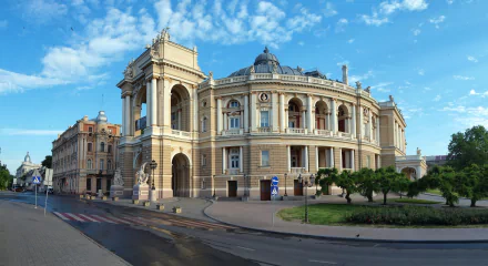 HD PC desktop wallpaper of the Odessa Opera House, Odessa, Ukraine — ornate man-made neoclassical building with domes, arches and sculptural details beneath a bright blue sky.