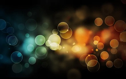 HD desktop wallpaper featuring an artistic bokeh effect with multicolored, blurred circles against a dark background.