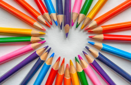 Colorful pencils arranged in a heart shape, creating a vibrant 4K Ultra HD desktop wallpaper showcasing vivid colors and artistic photography.