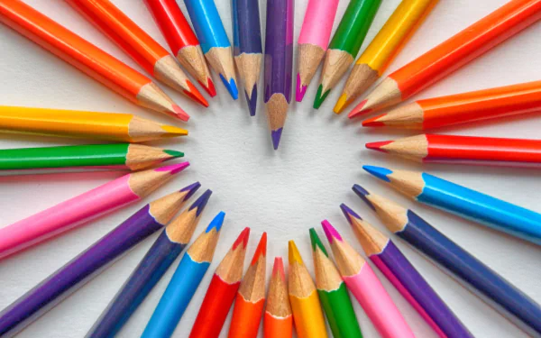 Colorful pencils arranged in a heart shape, creating a vibrant 4K Ultra HD desktop wallpaper showcasing vivid colors and artistic photography.