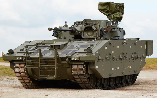 4K Ultra HD military armored personnel carrier positioned on a paved surface with an overcast sky in the background, designed for heavy-duty defense operations.