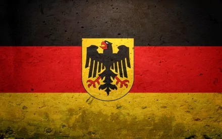 A textured HD wallpaper featuring the flag of Germany, showcasing the black, red, and gold colors with the national coat of arms prominently displayed in the center.