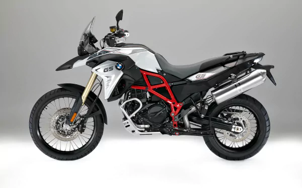 HD desktop wallpaper featuring a sleek BMW F800GS adventure motorcycle against a plain background.