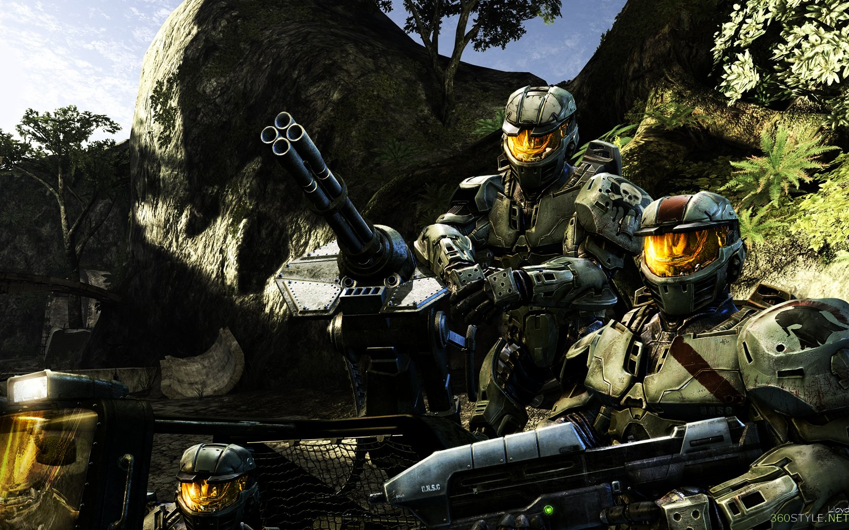 HD PC desktop wallpaper featuring armored soldiers from the video game Halo, set in a detailed, rocky outdoor environment with lush greenery.
