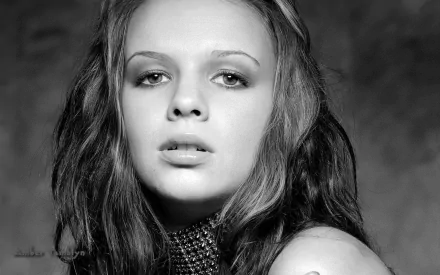 Black-and-white HD desktop wallpaper featuring a close-up portrait of actress Amber Tamblyn with a calm, neutral expression.