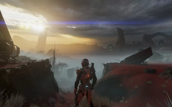 A stunning HD wallpaper depicting Scott Ryder from Mass Effect: Andromeda, standing against a dramatic alien landscape under a moody sky, with distant structures and a glowing sunset.