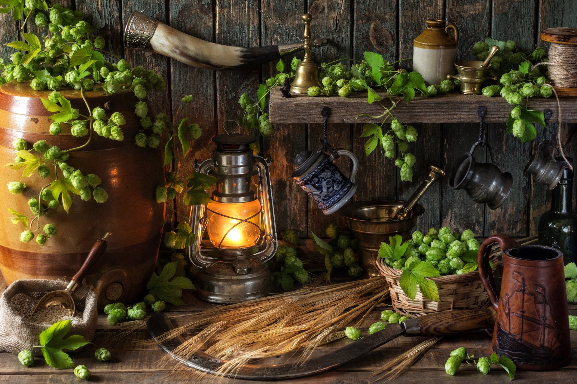 A still life image featuring hops, wheat, and a lantern set against a rustic wooden background, showcasing vibrant greenery and vintage utensils in 4K Ultra HD quality.