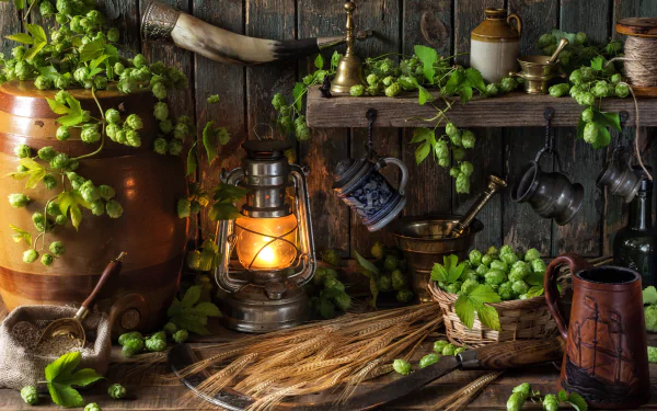 A still life image featuring hops, wheat, and a lantern set against a rustic wooden background, showcasing vibrant greenery and vintage utensils in 4K Ultra HD quality.