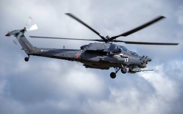 HD PC wallpaper featuring a Mil Mi-28 military attack helicopter in flight against a cloudy sky background.