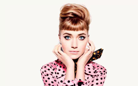 A vintage-style HD wallpaper featuring a retro-themed actress with brunette hair and striking blue eyes. She is dressed in a pink polka dot outfit and posing elegantly for the camera.