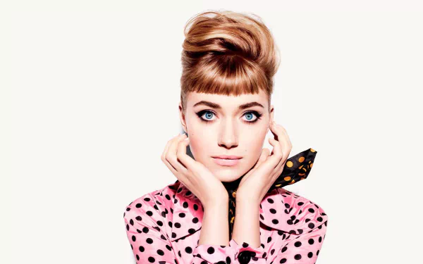 A vintage-style HD wallpaper featuring a retro-themed actress with brunette hair and striking blue eyes. She is dressed in a pink polka dot outfit and posing elegantly for the camera.