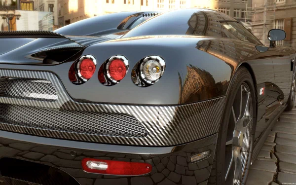 A sleek Koenigsegg CCX showcases its striking design and carbon fiber details, set against an urban backdrop in this high-definition desktop wallpaper.