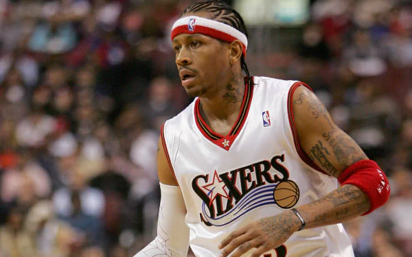 HD desktop wallpaper featuring a basketball player in a Philadelphia 76ers uniform on the court.