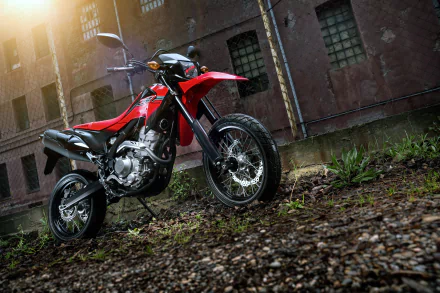 Red Honda CRF250M motorcycle parked on gravel with a building in the background, captured in 4K Ultra HD for a PC desktop wallpaper.