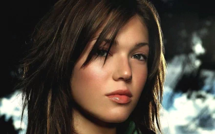 A close-up of Mandy Moore with soft lighting, capturing her striking features and expressive look, making for an engaging HD wallpaper background.