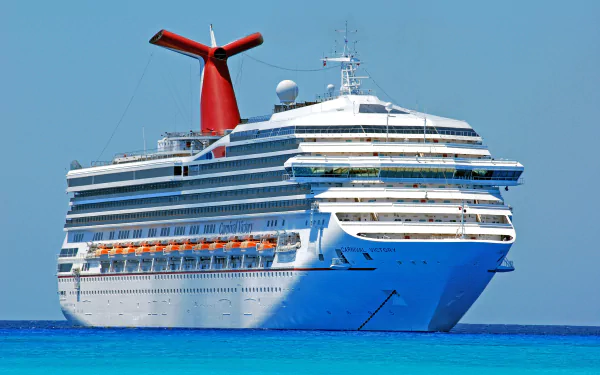 4K Ultra HD image of the Carnival Victory cruise ship sailing on clear blue waters, showcasing its distinctive red funnel and multiple decks.