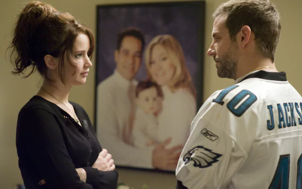 Jennifer Lawrence and Bradley Cooper in a scene from the movie Silver Linings Playbook, featured on a HD PC desktop wallpaper and background.
