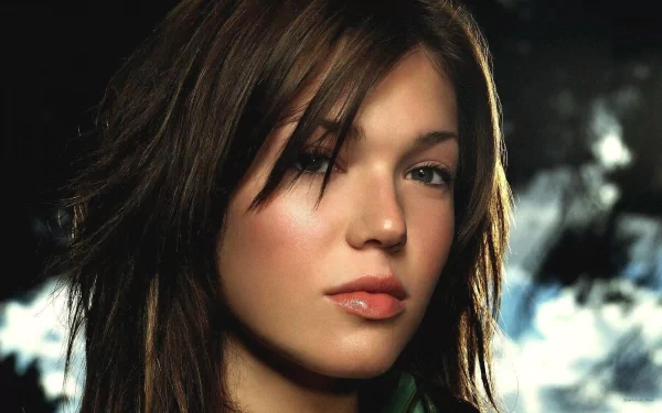 A close-up of Mandy Moore with soft lighting, capturing her striking features and expressive look, making for an engaging HD wallpaper background.