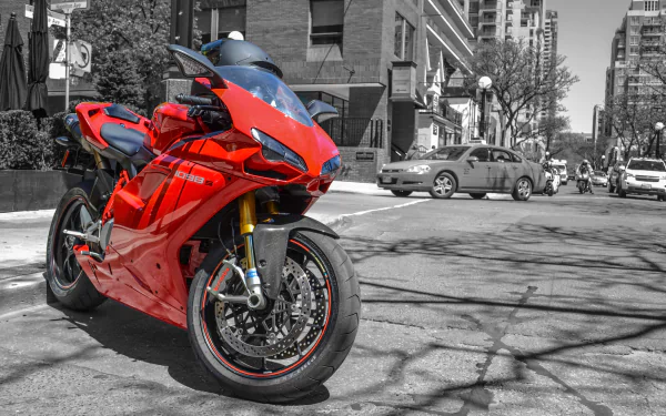 A striking red Ducati 1098 motorcycle stands out in selective color against a black-and-white urban street background, featured as a HD PC desktop wallpaper.