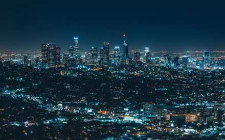 Nighttime cityscape of Los Angeles with illuminated skyscrapers and sparkling city lights, captured in high definition as a vibrant urban PC desktop wallpaper.