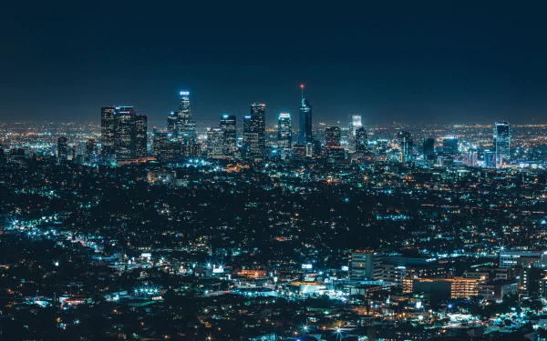 Nighttime cityscape of Los Angeles with illuminated skyscrapers and sparkling city lights, captured in high definition as a vibrant urban PC desktop wallpaper.