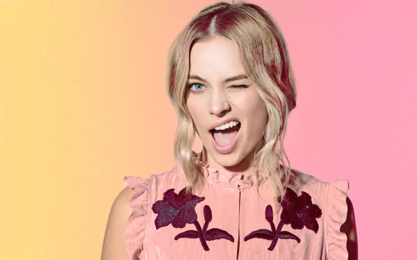 Image of Australian actress Margot Robbie with blue eyes and blonde hair, winking playfully against a gradient background of yellow and pink. This HD desktop wallpaper captures her vibrant personality.
