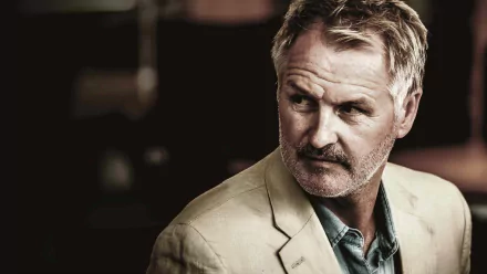 HD desktop wallpaper featuring a distinguished man in a beige suit, providing an elegant background aesthetic.