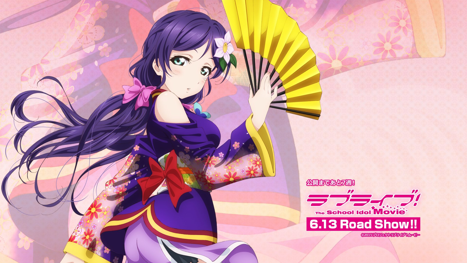HD desktop wallpaper featuring Nozomi Tojo from the anime Love Live! She is depicted in a vibrant kimono, holding a yellow fan against a pastel background with text promoting the Love Live! movie.