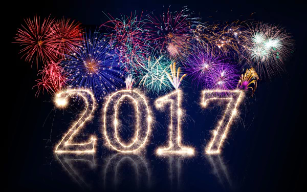 HD desktop wallpaper featuring colorful fireworks in the night sky with 2017 illuminated in sparklers, celebrating New Year 2017.