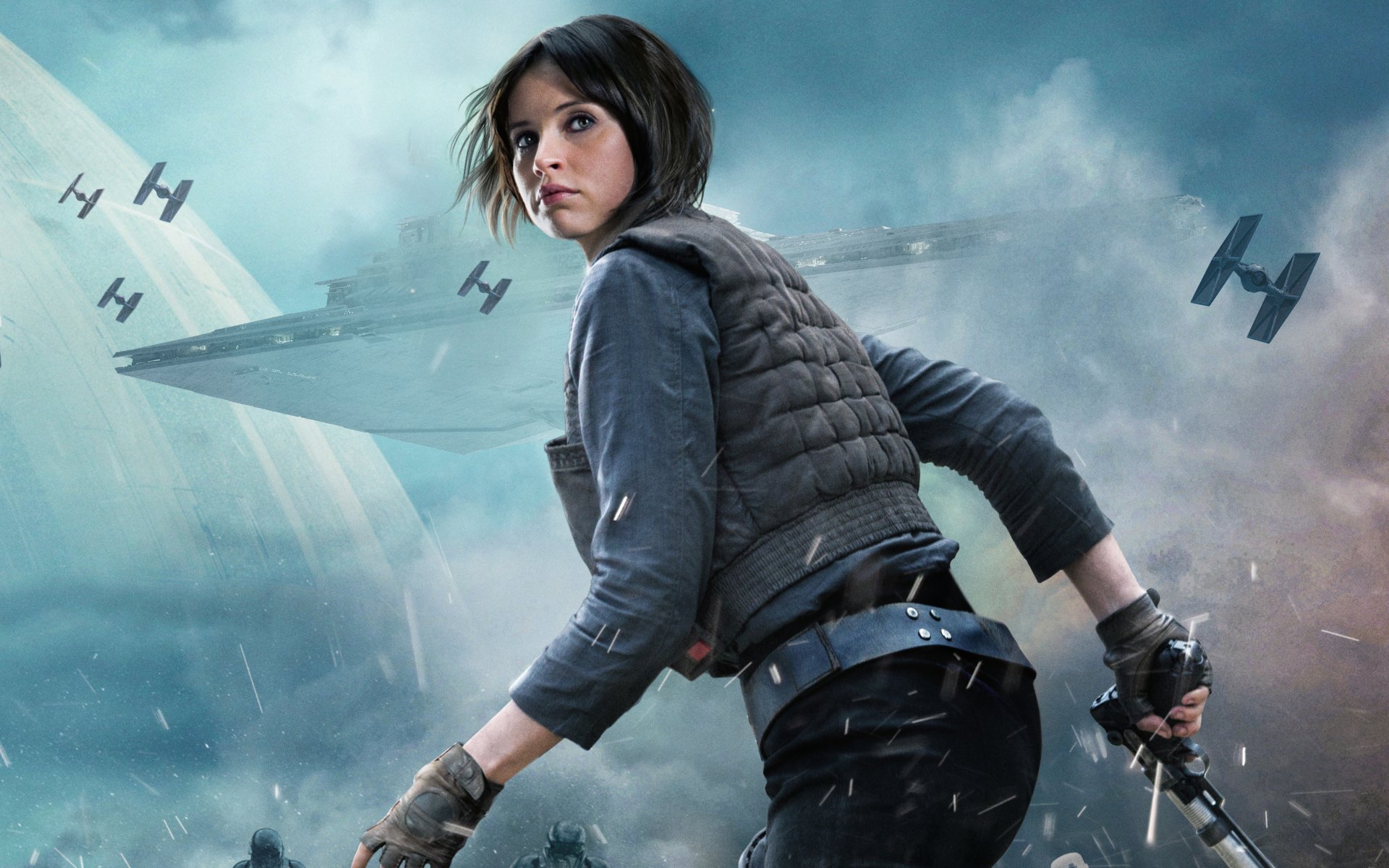 HD desktop wallpaper and background of Felicity Jones as Jyn Erso in the movie Rogue One: A Star Wars Story, featuring a dramatic space scene with TIE fighters and a Star Destroyer.