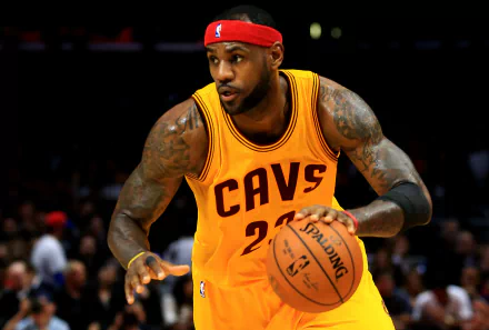 HD desktop wallpaper featuring a basketball player in a yellow Cavs jersey dribbling during a game.