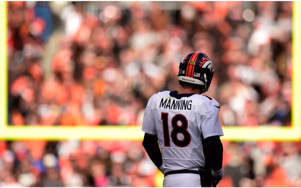 HD desktop wallpaper featuring a player with the name Manning and number 18 on his jersey, standing on a football field with a crowd in the background.