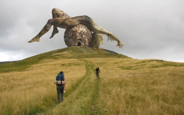 A stunning CGI artwork depicting a monumental fallen figure on a grassy hill, with two hikers approaching. This digital art piece serves as a captivating HD desktop wallpaper.
