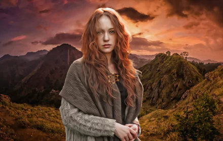 A woman with long red hair stands in front of a mountainous landscape during sunset, captured in an oil painting style. This HD wallpaper showcases artistic beauty and natural serenity.